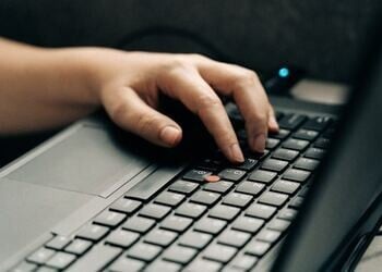 hand typing on keyboard